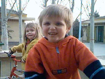 Matthew on his new bike followed by Charlotte